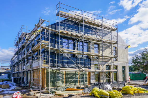 reconstruction of an old house with extension, scaffolding around the house