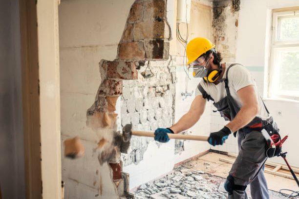 Worker using hammer, home renovation